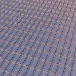 A grid of rectangular structures, possibly a quantum processor, is illuminated with a pink and purple gradient.