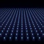 A regular grid of bright points of light suspended in a dark plane