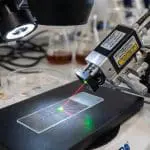 A laser positioning rig aimed at a microscope slide