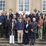 Researchers and delegates posed on the steps of a stone building