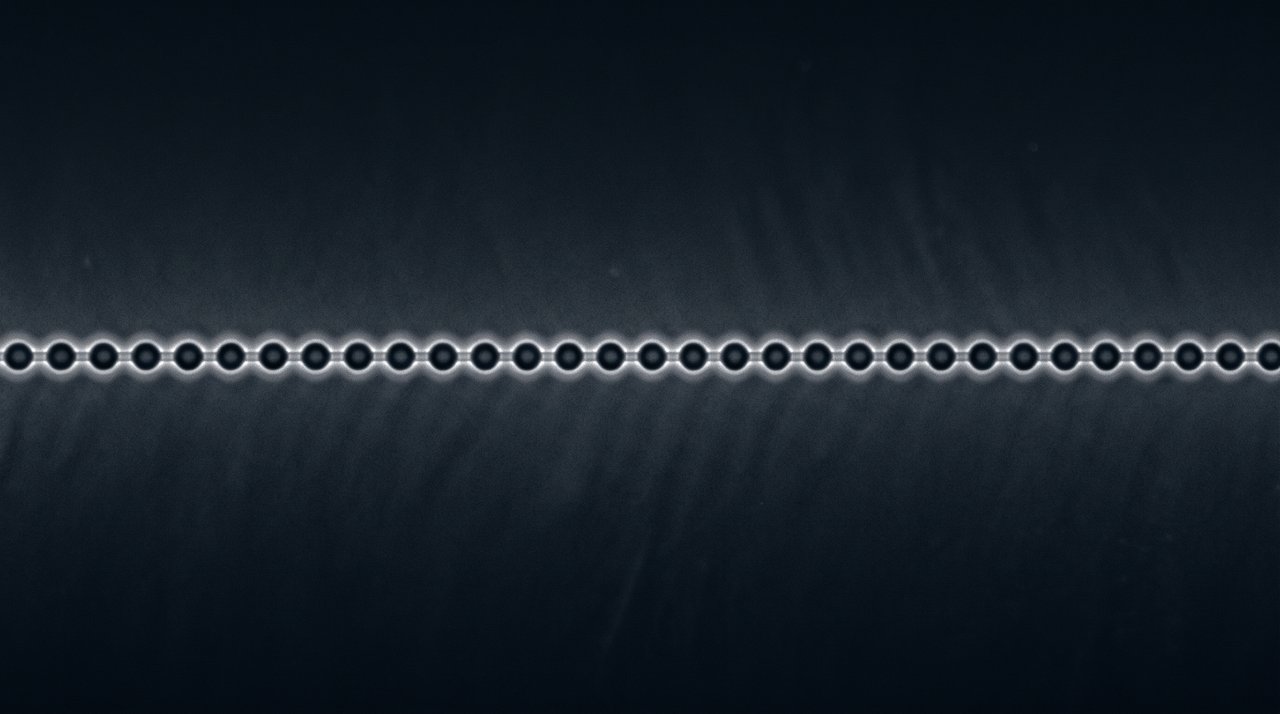 An abstract row of evenly spaced grey spheres
