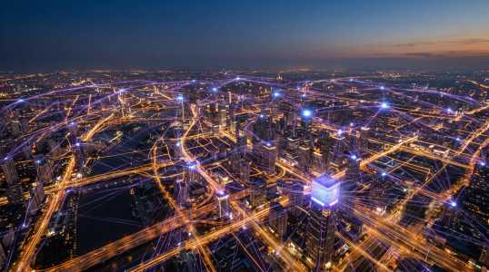 aerial dusk view of a city laced with glowing purple network links between rooftops