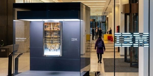 IBM Quantum System One on display in a corporate lobby beside an illuminated IBM logo