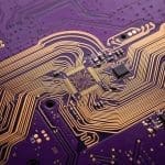 Gold traces fanning out across a circuit board