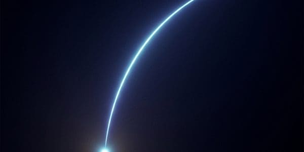 A bright blue point of light at lower left with a thin curved arc of light sweeping upward and to the right across darkness.