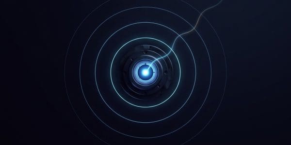 A small metallic device with a bright blue glowing center emits concentric circular rings and a thin filament of light.