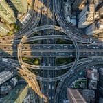 Planned Cities Optimise Quantum Algorithms More Reliably Than Organic Layouts