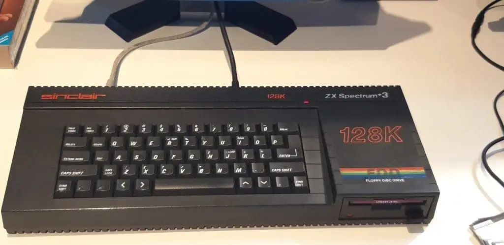 Launched in 1987, the ZX Spectrum +3 retained a similar design to its predecessor but replaced the cassette drive with an integrated 3-inch floppy disk drive. Initially sold for £249, it was later reduced to £199. Notably, it was the only Spectrum model capable of running the CP/M operating system without requiring extra hardware. Unlike earlier models, the ZX Spectrum +3 used a power supply with a DIN connector and displayed "Sinclair +3" branding on its casing.